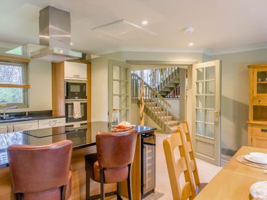 A kitchen with an island and dining area at The Derwent Spa (Pet) in Slaley
