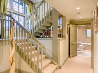 A hallway with stairs and a bathroom door at The Derwent Spa (Pet) Slaley