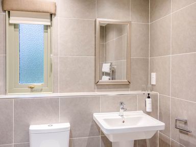 A bathroom with a toilet and sink at The Derwent Spa (Pet) in Slaley