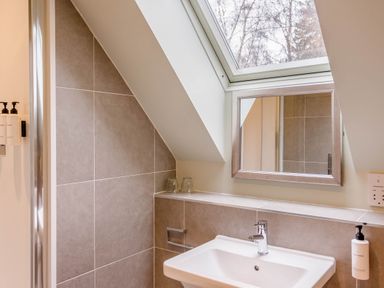 A bathroom with a sink and mirror at The Derwent Spa (Pet) in Slaley