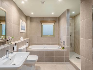 A bathroom with a bathtub, sink and shower at The Derwent Spa (Pet) Slaley