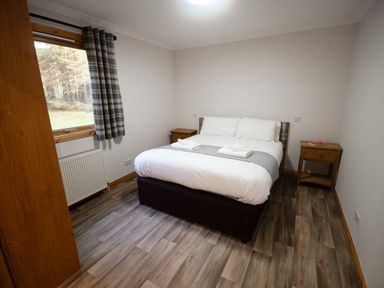 A bedroom with a bed and bedside tables at Sidlaw Fowlis near Dundee