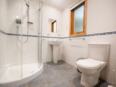 A bathroom with a shower, toilet, and sink at Sidlaw in Fowlis near Dundee
