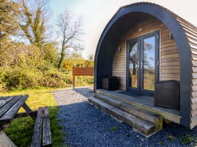 An outdoor view of a pod with steps and garden at Bron Eifion Pod 1 Criccieth