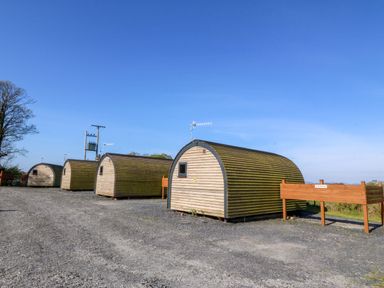 A row of glamping pods at Bron Eifion Pod 1 in Criccieth