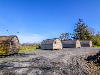 Wooden cabins on gravel ground at Bron Eifion Pod 1 Criccieth