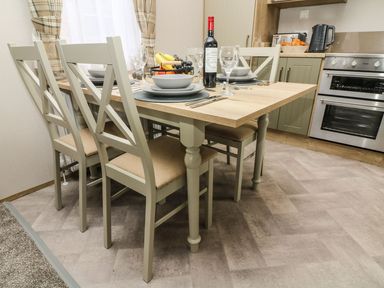 A dining room with a table set for dinner at Hedgehog Lodge in Carnforth