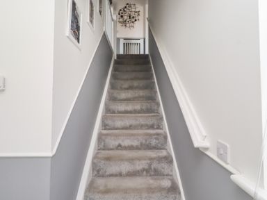 A staircase leading to a landing at 26 Field Court