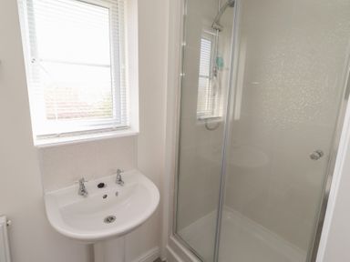 A bathroom with a sink and shower at 26 Field Court