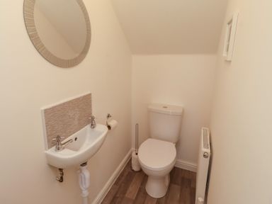 A bathroom with a sink and toilet at 26 Field Court