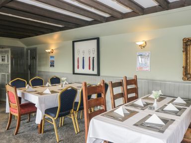A dining room with tables and chairs at Lochwood Platinum Superior at Three Lochs Holiday Park in Newton Stewart