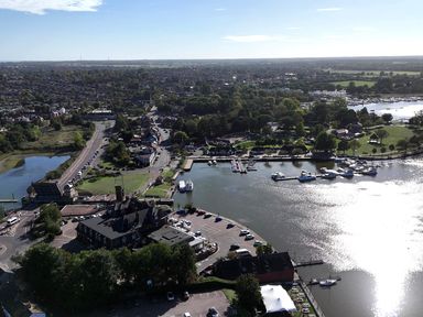 An aerial view of a marina and surrounding area at The Mill House Gardens in Oulton Broad