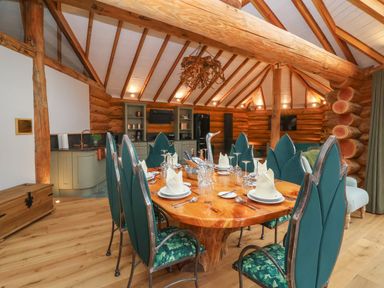 A dining room with a wooden table and chairs at Copper Suite in Chulmleigh
