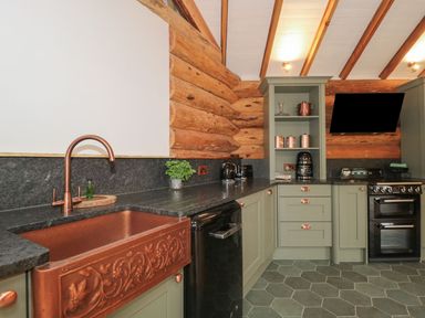 A kitchen with a copper sink and countertop at Copper Suite in Chulmleigh
