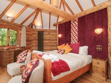 A bedroom featuring a bed with pillows and table at Copper Suite in Chulmleigh