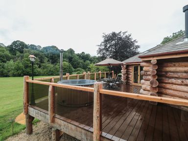 An outdoor area with a hot tub and seating at Copper Suite in Chulmleigh
