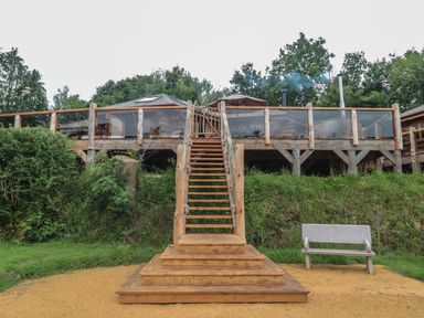 An outdoor area with wooden steps leading to a deck at Copper Suite in Chulmleigh