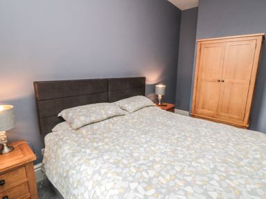 A bedroom with a bed and wardrobe at 5 Station Avenue