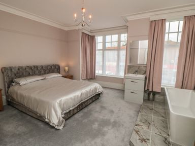 A bedroom with a bed and a bathtub at 5 Station Avenue