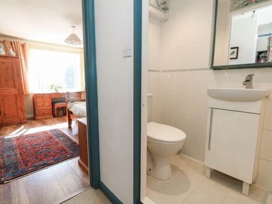 A bathroom with a toilet and sink at Dunvant in Swanage