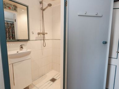 A bathroom with a shower and sink at Dunvant in Swanage