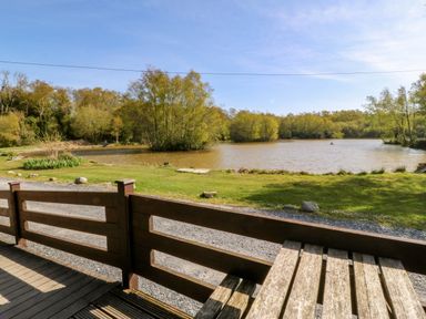 An outdoor area with a lake and trees at Lodge 6 - Sleep 4 - Twin and Double in Criccieth