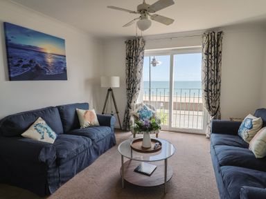 A living room with sofas and a coffee table at 2 Lyme Mews in Seaton