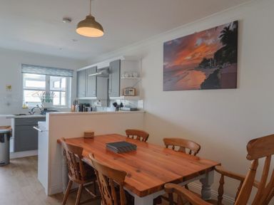 A kitchen with a dining table and chairs at 2 Lyme Mews Seaton
