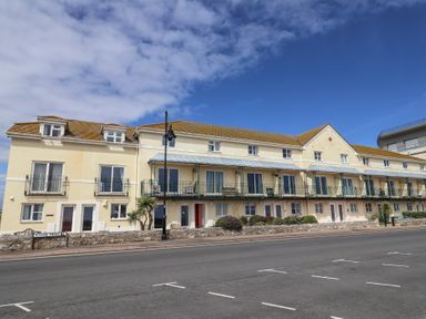 A building with multiple balconies and windows at 2 Lyme Mews in Seaton