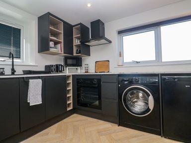 A kitchen with appliances and cabinets at The Annex in Penzance