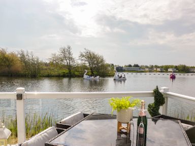 An outdoor area with a lake and swan-shaped boats at Swan Haven in Grange-Over-Sands
