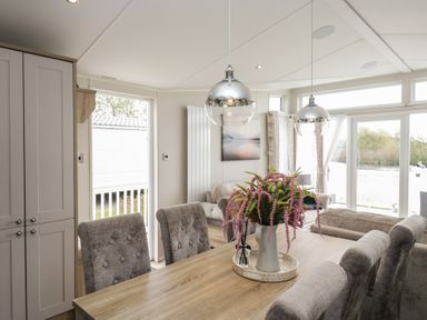 A dining area with a table and chairs at Swan Haven in Grange-Over-Sands