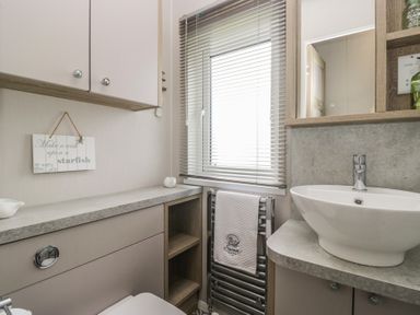A bathroom with a sink and toilet at Swan Haven in Grange-Over-Sands