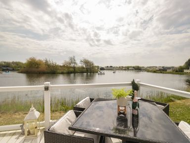 An outdoor dining area with a view of the water at Swan Haven in Grange-Over-Sands