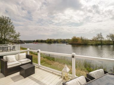 A river view with seating and boats at Swan Haven Grange-Over-Sands