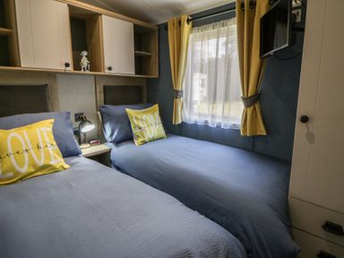 A bedroom with two beds and a window at Santa Maria in Llandysul