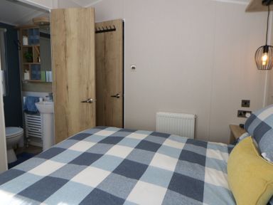 A bedroom with a view of the bathroom door at Santa Maria in Llandysul