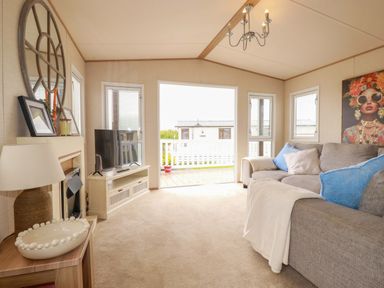 A living room with a sofa and television at CC2