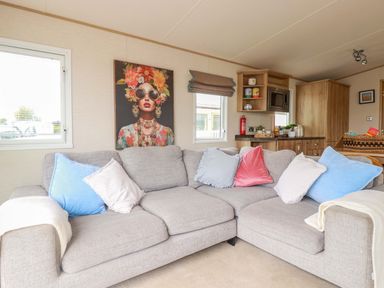 A living room with a sofa and wall art at CC2