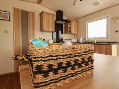 A kitchen with a basket on the table at CC2