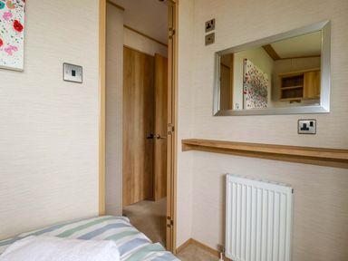 A bedroom with a mirror and a shelf at CC2