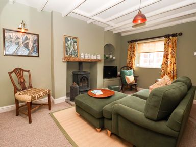 A living room with a sofa and chair at The Cook’s Cottage in Malton