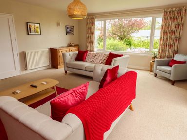 A living room with sofas and a coffee table at Campden in Rennington near Embleton