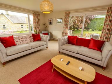 A living room with sofas and a coffee table at Campden in Rennington near Embleton