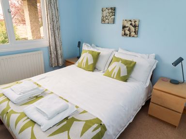 A bedroom with a bed and bedside table at Campden in Rennington near Embleton