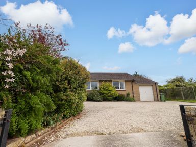 A house with a garage and driveway at Campden in Rennington near Embleton