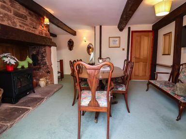 A dining room with a table and chairs at Pete's Place in Taunton
