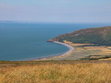 A beach coastline with hills and fields at Pete's Place in Taunton