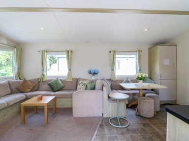 A living room with a sofa and table at Forest Retreat - FO26, Saxmundham