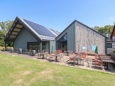 An outdoor area with tables and chairs at Forest Retreat - FO26 Saxmundham